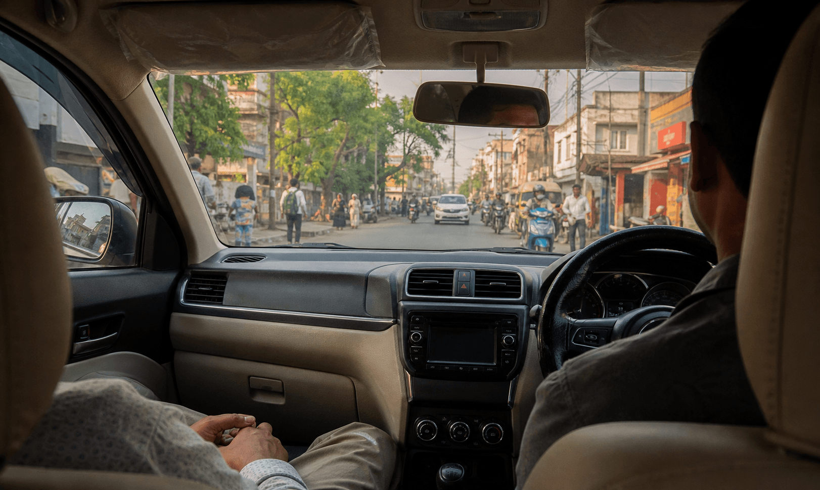 Back-seat view inside a clean taxi on an ordinary city road
